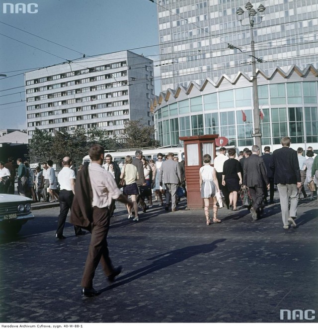 Widok od ul. Marszałkowskiej. Na jezdni przechodnie, w tle flagi państwowe. Z lewej fragment samochodu Moskwicz 408.
Data wydarzenia: 1966 - 1969