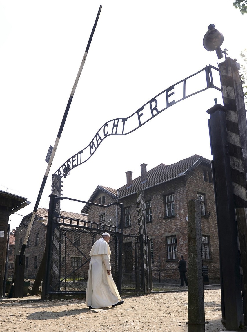 Pope francis walks through the gate of the former nazi...