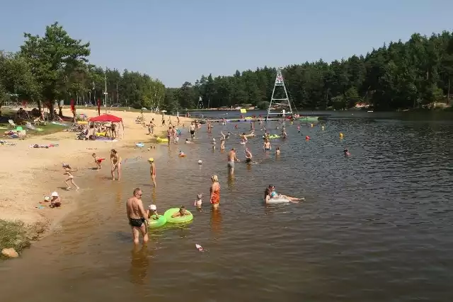 Zalew w Kaniowie to miejsce wypoczynku dla całych rodzin. Nad bezpieczeństwem pływających czuwają ratownicy. W tle wyciąg o wakeboardingu.