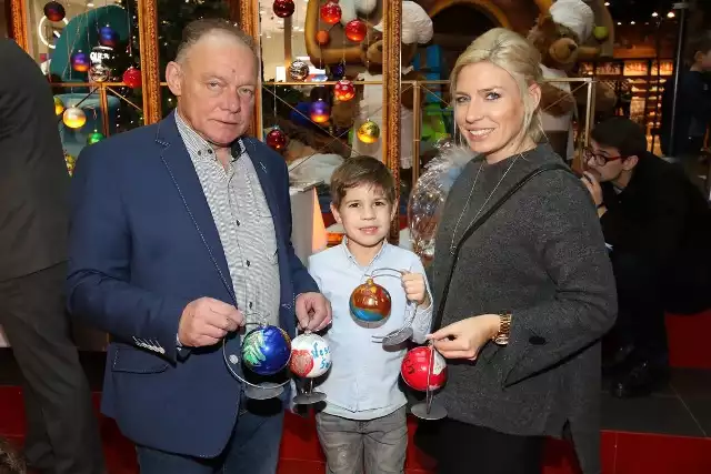 Janusz Banatkiewicz właściciel znanej Cukierni Banatkiewicz z córką i wnuczką malowali bombki z elementami świątecznymi.