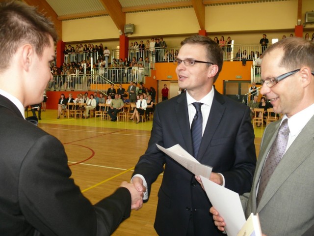 Dyrektor szkoły Mariusz Potasz i starosta Robert Fila wręczają najlepszym uczniom dyplomy.