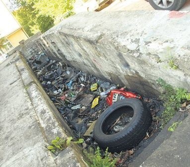 Zalany olejem i zasypany toksycznymi śmieciami kanał samochodowy na zapleczu ul. Partyzantów w Koszalinie, po sąsiedzku z ogródkami działkowymi.