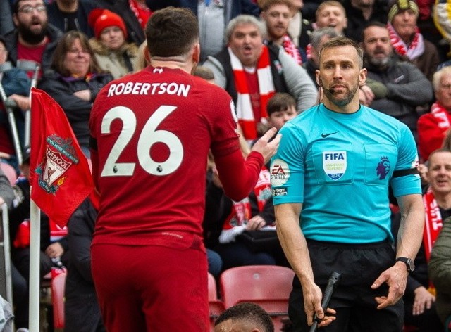 Andy Robertson i sędzia liniowy Constantine Hatzidakis podczas meczu Premier League Liverpool - Arsenal na Anfield