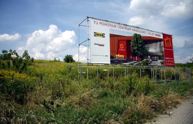 Billboard ustawiony na działce podpowiada przechodniom, co w przyszłości może powstać w tym miejscu