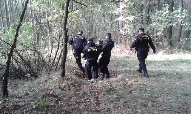 Policjanci niosą wyczerpanego 78-latka odnalezionego we wtorek w okolicach Ciekot