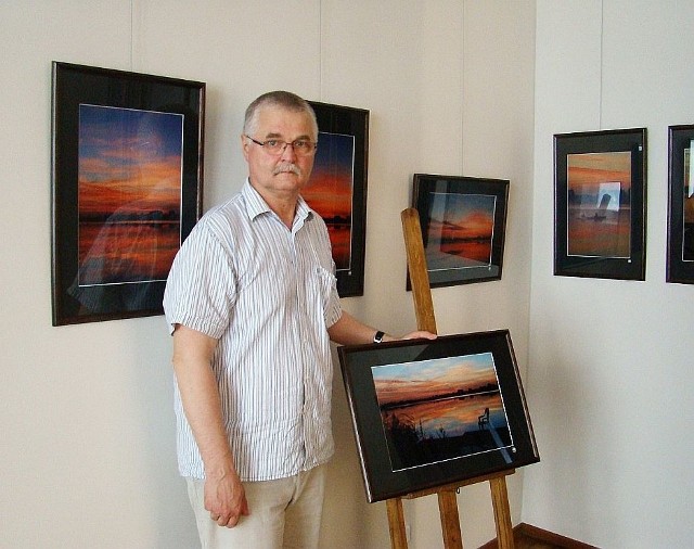Zenon Lewicki na tle kilku swoich prac pokazywanych na wystawie w inowrocławskim muzeum