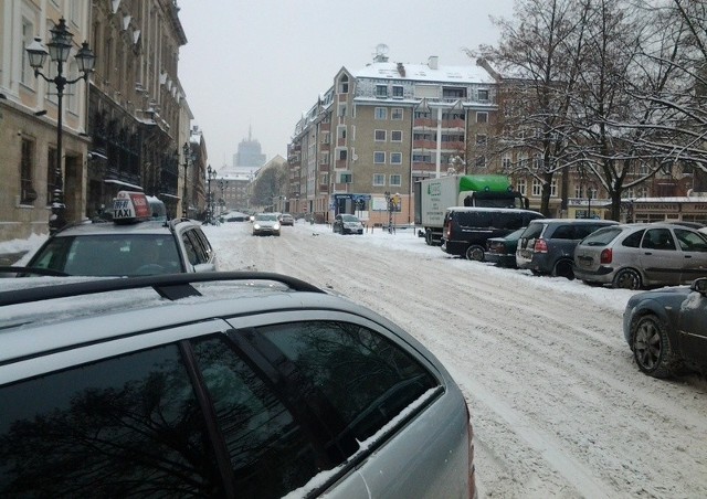 Nieodśnieżona ulica i parkingi  w Szczecinie na placu Orla Białego.