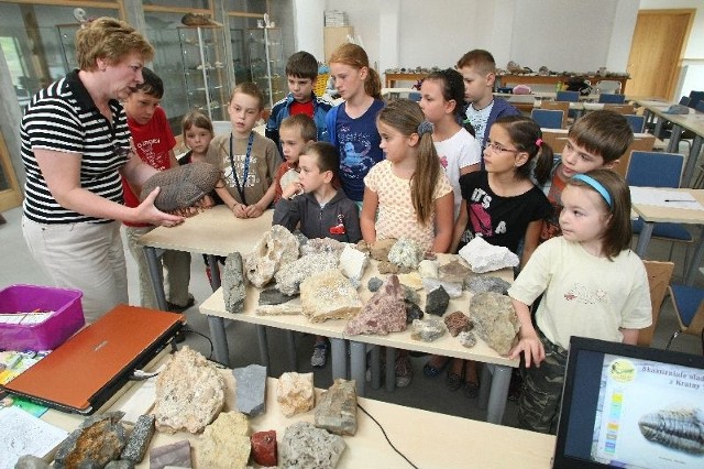 Barbara Jędrychowska, kierownik Klubu Miłośników Geologii, pokazuje dzieciom, jak odróżniać i kwalifikować skamieniałości.