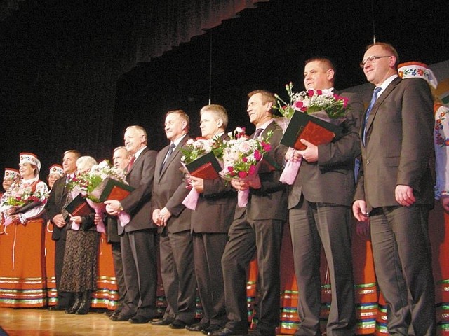 Zasłużeni na scenie. Od prawej: Andrzej Skiepko, wicestarosta hajnowski, Jarosław Kot, Sławomir Smyk, Aleksander Sielicki, Włodzimierz Pietroczuk, starosta hajnowski, Anatol Ochryciuk, Anatol Pawłowski, Maria Zdanowska i Mikołaj Michaluk, przewodniczący rady powiatu, w towarzystwie laureata zbiorowego - zespołu pieśni "Echo Puszczy".