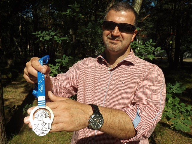 Jacek Domański, dyrektor GOSTiR-u w Dźwirzynie prezentuje tegoroczny medal za udział w Biegu Ku Słońcu. Dostanie go każdy uczestnik