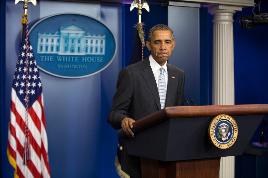 President barack obama pauses as he speaks about attacks in...