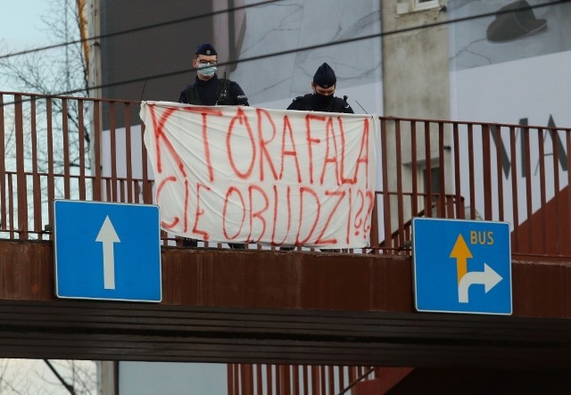 Policja usuwa transparent z kładki nad ulicą Legnicką we Wrocławiu 18.03.2021