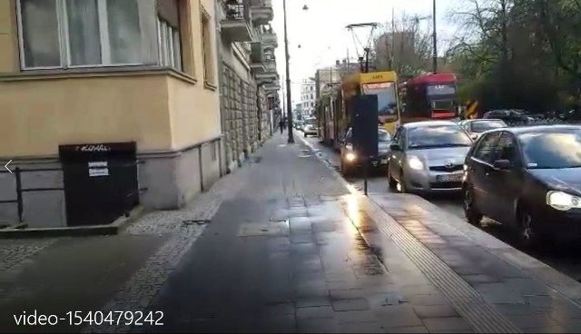 Trzy kadry z filmu. Zakorkowana ul. Kilińskiego, mijające się tramwaje. Karetka nie ma jak się przebić. Udaje się dopiero, gdy auta blokujące tramwaje ruszają spod świateł.