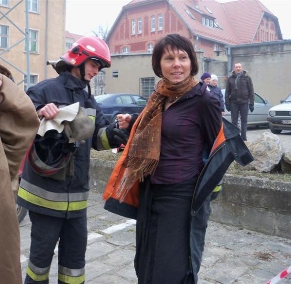 Jolanta Barska wkłada strażacki uniform.