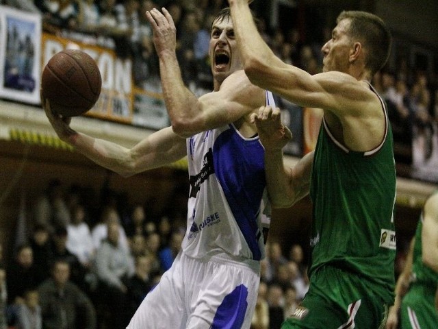 Adam Cichoń ( w białej koszulce) w dynamicznej akcji pod koszem Legii.