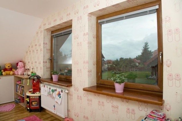 Okno w pokoju dzieckaProducenci oferują okna przyjazne i bezpieczne dla dzieci, choćby okna z klamką na kluczyk albo przyciskiem zabezpieczającym przed otwarciem okna oraz bezpieczną szybę.