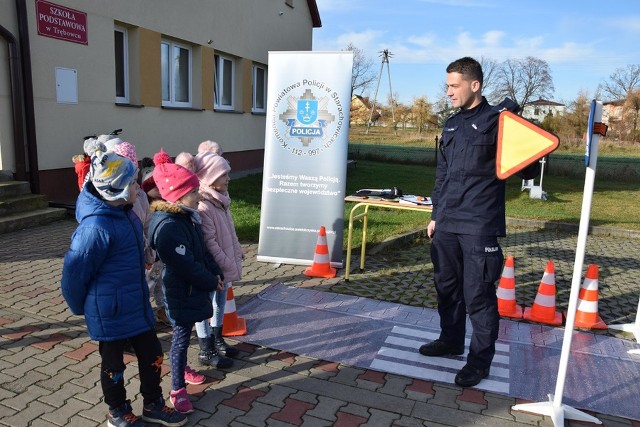 Policjant z komendy w Starachowicach prezentuje dzieciom znaki drogowe