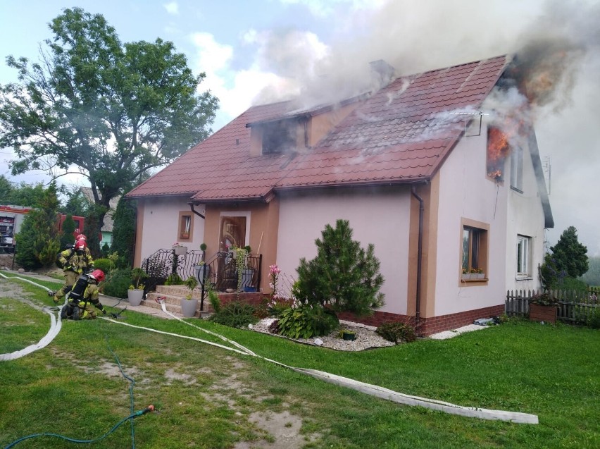 Pożar w Trutnowach gm. Cedry Wielkie 22.07.2021. Ogień objął poddasze domu. Strażak uratował mężczyznę