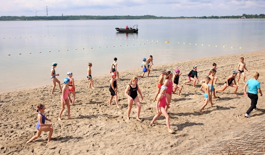 III Triathlon Kids nad jeziorem w Tarnobrzegu. Młodzi sportowcy rywalizowali w pływaniu, jeździe rowerem i biegu. Zobacz zdjęcia i wideo