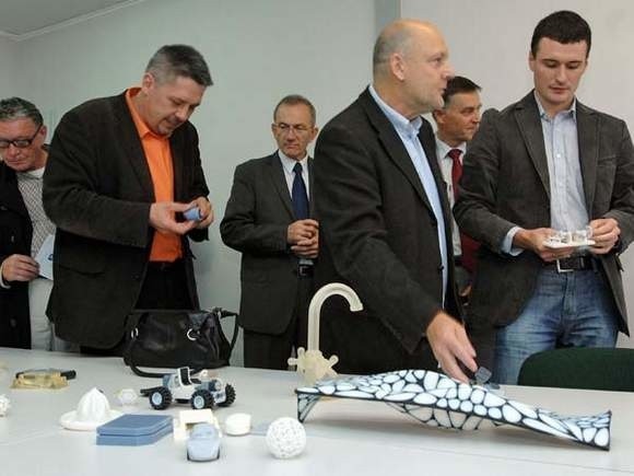 Podczas otwarcia laboratorium prof. Jacek Ojrzanowski (na pierwszym planie) prezentował modele wykonane dzięki drukarkom 3D.