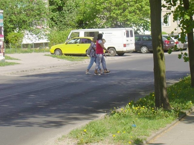 Przez ulicę 1 Maja co chwilę przebiegają przechodnie. Ryzykują sporo, bo samochody jeżdżą tu często.