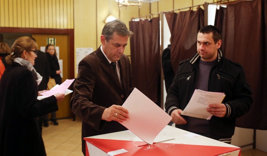 Arseniusz Finster wrzuca głosy do urny wyborczej