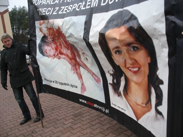 Na transparencie rozstawionym przed kościołem widniała fotografia posłanki Marzeny Okły-Drewnowicz, a obok zdjęcie martwego płodu.