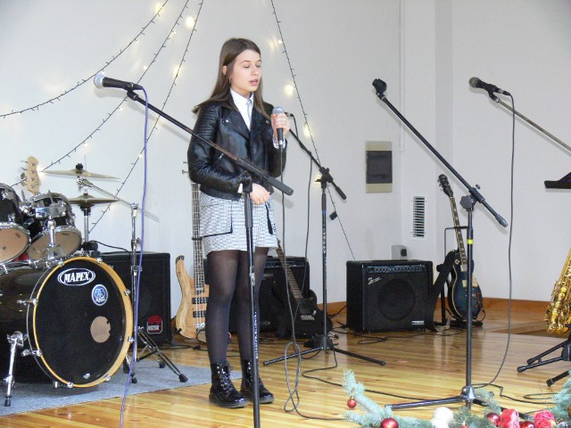 Na scenie Amelia Szlichta ze Szkoły Podstawowej w Niedźwicach, która zaśpiewała kolędę "Dla nieobecnych".