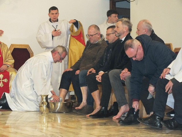 Ksiądz proboszcz Sławomir Rak umywa nogi dwunastu mężczyznom.