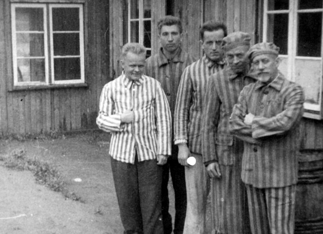 Grupa byłych więźniów na terenie Stutthofu w 1946 roku, zdjęcie wykonano prawdopodobnie przy okazji uroczystości 7 września 1946 r. W tle barak na terenie Starego Obozu