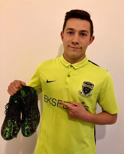 Marcin Szafczyk prezentuje wylicytowane buty piłkarskie,...