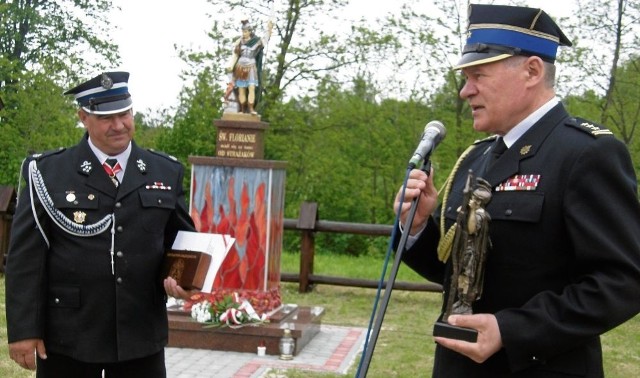 Władysław Szumera (z lewej), prezes Ochotniczej Straży Pożarnej  z Pstroszyc  odebrał od Adama Domagały figurkę św. Floriana