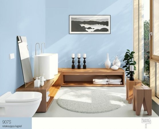Łagodny błękit ścian, biała ceramika sanitarna i drewniane...