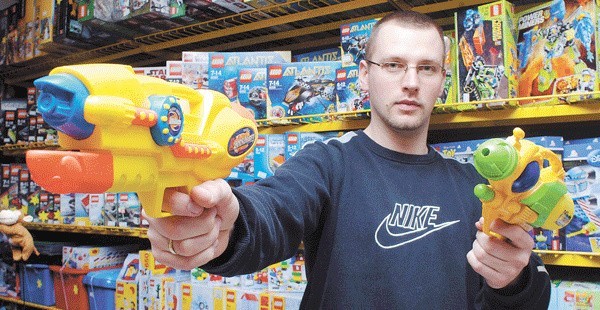 Michał Deskiewicz ze sklepu z zabawkami Troll w Koszalinie prezentuje jeden z popularniejszych modeli wodnych pistoletów, który kosztuje 22 zł. 