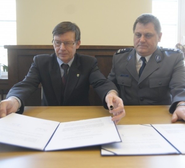 Na zdjęciu prezydent Opola i komendant miejski wymieniają się umowami. Miasto zobowiązało się przekazać policji  200 tys. zł.