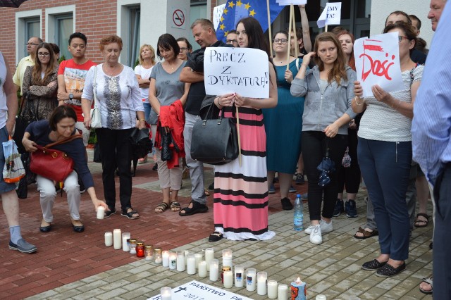 "Z głębokim żalem zawiadamiamy, że w dniu 20 lipca 2017 r. zginęła w zamachu przeżywszy 28 lat III Rzeczpospolita Polska ur. 4 czerwca 1989 r.na skutek wolnego wyboru Polaków. Uroczystości pogrzebowe nie odbędą się. Pogrążeni w smutku Polacy." - taka klepsydra pojawiła się przy stojących zniczach przed Sądem Rejonowym w Słubicach. W strugach deszczu w Słubicach również demonstrowali swój  sprzeciw wobec zmian ustaw regulujących pracę sądów w Polsce. Obecni na proteście uważają, że proponowane przez PiS zmiany są niezgodne z Konstytucją RP, naruszają demokratyczne wartości i skutkować będą zmianą ustroju Polski, w którym pełnia władzy skupiona będzie w rękach jednej partii. - Taka sytuacja nie ma nic wspólnego z zasadami demokratycznego państwa prawa - mówi Robert Włodek, szef słubickiego Sojuszu Lewicy Demokratycznej. - Wygrane wybory parlamentarne przez PiS nie dają tej partii mandatu do wprowadzania zmian ustrojowych w Polsce. Te wymagają akceptacji ogółu Polaków, choćby w formie referendum ustrojowego. Chcę żyć w wolnym kraju, a to, co dzisiaj dzieje się w sejmie niewiele wspólnego ma z demokracją. Ja nie chcę protestować. Ja muszę protestować, bo to jest po prostu walka o fundamentalne zasady, o wartości - dodaje.Przed sąd przyszła ponad setka ludzi w różnym wieku z różnych miejscowości. Były Słubice, Rzepin, Cybinka, Ośno i Górzyca. Protest zgromadził przedstawicieli wszystkich słubickich partii, byli: : starosta słubicki Marcin Jabłoński (PO), Leopold Owsiak (PSL), Amelia Szołtun (Stowarzyszenie Wspólnie dla Samorządu - były członek Prawa i Sprawiedliwości)) i organizatorzy protestu Robert Włodek (Sojusz Lewicy Demokratycznej)i Bernard Łysiak (Partia Razem). W tym momencie nie liczyły się podziały polityczne. Cel był jeden: bronić państwo przed bezprawiem.Atmosfera była naprawdę bardzo gorąca, każdy chciał coś powiedzieć, mieszkańcy bez żadnego zażenowania chwytali mikrofon i mówili co im leży na sercu. - Całe życie jestem bezpartyjny, dokładnie pół życia przeżyłem za komuny, a pół w wolnej Polsce. Kraj się rozwija, mamy autostrady, mamy inwestycje, a okazuje się, ze jesteśmy w ruinie! - mówił Dariusz Krzeptowski ze Słubic.- Moja babcia była w obozie koncentracyjnym, a mój dziadek pracował dla Niemca, po to, żebyśmy teraz mogli spokojnie żyć w tej wolnej Polsce. I co teraz się dzieje? Znów musimy o nią walczyć? - pytała Ewa Zalewska, 33 - letnia mieszkanka Słubic.Głos zabrali także studenci Collegium Polonicum. - Fajnie, ze mimo takiej pogody przyszło tyle osób, które chcą powiedzieć, ze to co się dzieje, im się nie podoba. I mówcie o tym głośno, mówcie o tym w domu, w pracy, w sklepie. Rozmawiajcie ze wszystkimi, bo niestety duża część społeczeństwa nie ma wiedzy na ten temat. Musimy sobie te informacje przekazywać. Niezależność sądownictwa, tak samo jak Państwo prawa i demokracja są wartościami, bez których Polska nie będzie istnieć - mówił Michał Olczak, student prawa z Kamienia Pomorskiego.Zobacz też wideo: Manifestacja przed sądem w Zielonej GórzePrzeczytaj też:  W Zielonej Górze piąty dzień manifestowali w obronie sądów [WIDEO, ZDJĘCIA]