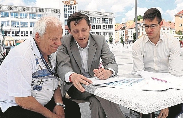 W ratuszu prace nad budżetem obywatelskim nadzoruje sekretarz Tomasz Czuczak (w środku); tu konsultacje z mieszkańcami na Rynku Staromiejskim.