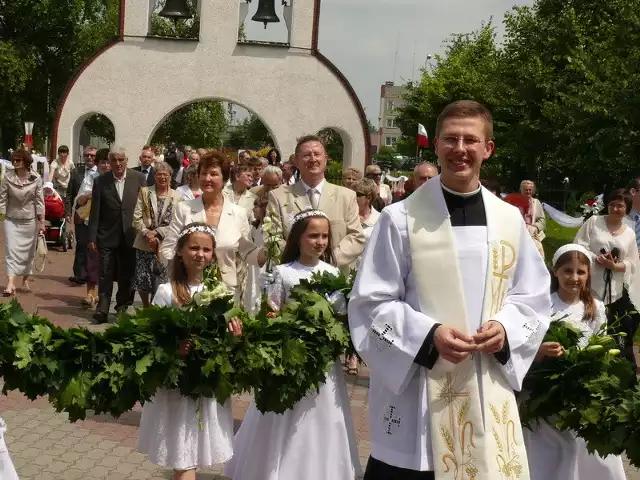 Ks. Konrad Zaborowski idzie w orszaku na mszę prymicyjną, za nim jego rodzice.