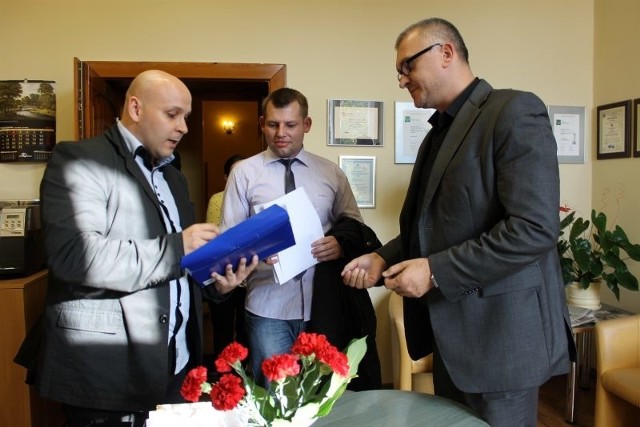 Tomasz Kwarciński (z lewej) podczas wręczenia burmistrzowi Sławomirowi Kowalowi wniosku o referendum w sprawie jego odwołania