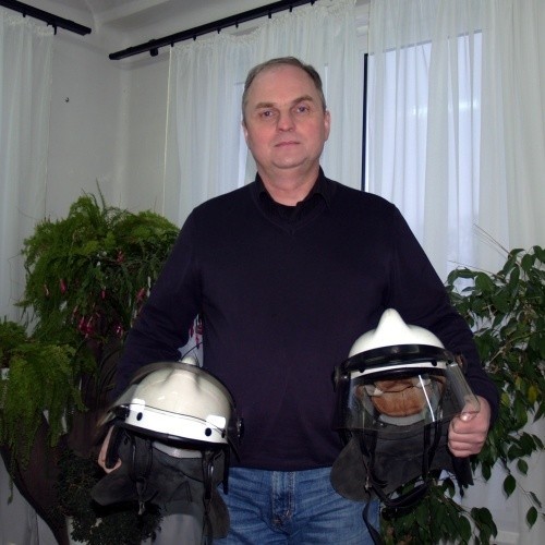 Andrzej Karpiński, dyrektor Suchedniowskiego Ośrodka Kultury Kuźnica, prezentuje strażackie kaski, które miejscowi druhowie przekazali na licytację na rzecz fundacji Jurka Owsiaka.