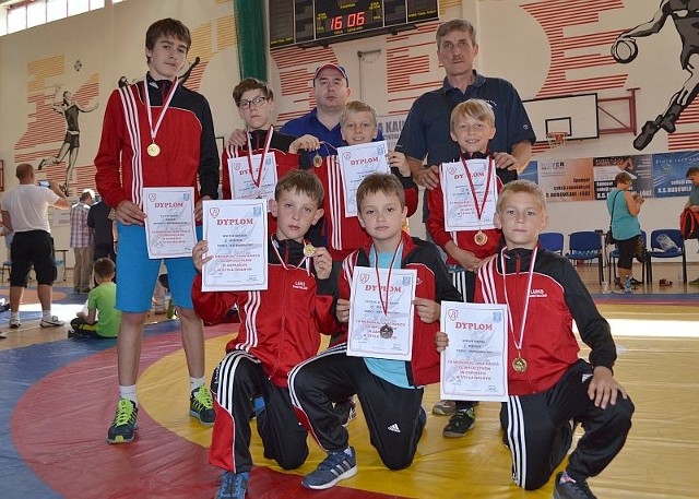 Zawodnicy Orła z medalami i trenerami klubowymi.