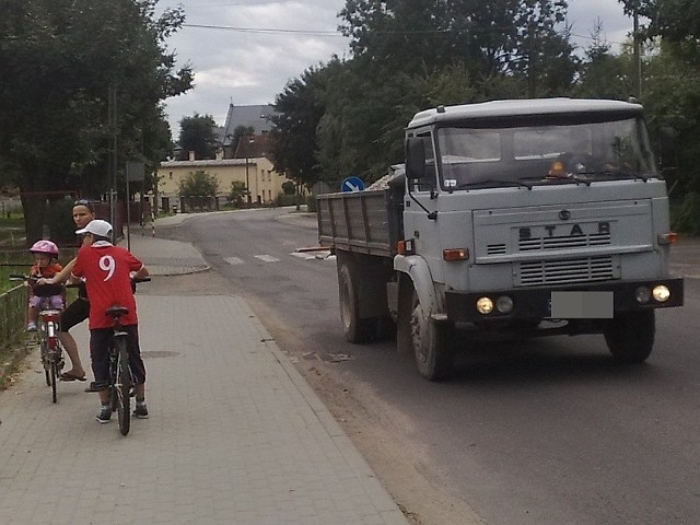 Załadowane ciężarówki nie tylko niszczą drogi we wsiach, ale są też zagrożeniem dla bezpieczeństwa rowerzystów i zmierzających do szkoły dzieci.