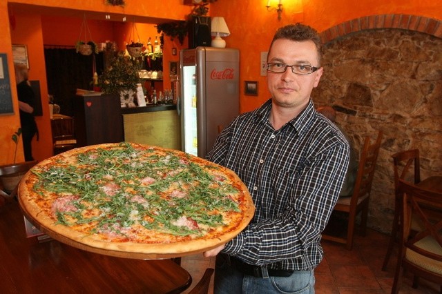 Aleksander Orszulak, właściciel pizzerii dumnie prezentuje familijną 61 &#8211; centymetrową pizzę "Vergine&#8221;.