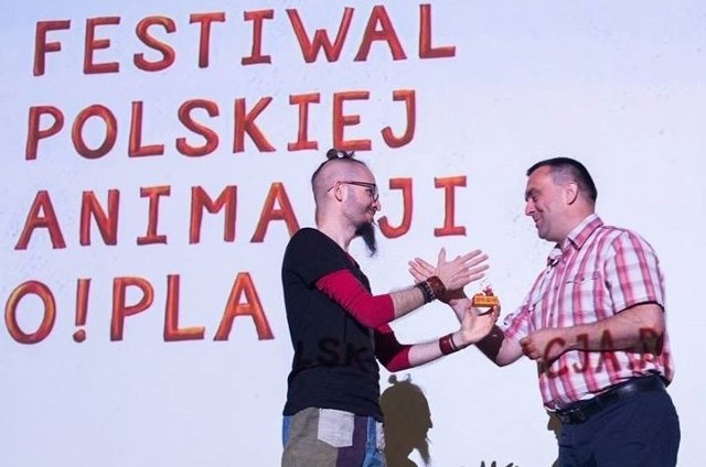 Grzegorz Krzywonos (z prawej) odbiera nagrodę specjalną za 5 lat działalności z Ogólnopolskim Festiwalem Polskiej Animacji.