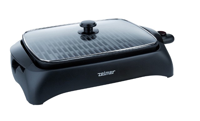 Grill elektryczny Zelmer 40Z011Elektryczny grill stołowy wyposażony jest w płytę opiekającą, która pozwala zachować smak i aromat potraw. Urządzenie szybko się nagrzewa. Ma termostat z pięcioma zakresami temperatur oraz pojemnik na ociekający tłuszcz.