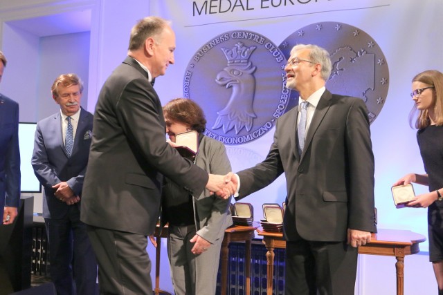 Edward Kuczer, prezes Gwaranta (z lewej), odbiera medal i gratulacje podczas gali w Warszawie.