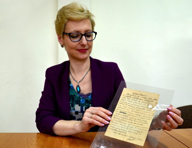 Anna Wójcik, szefowa archiwum Państwowego Muzeum na Majdanku, pokazuje gryps Janusza Krupeckiego.