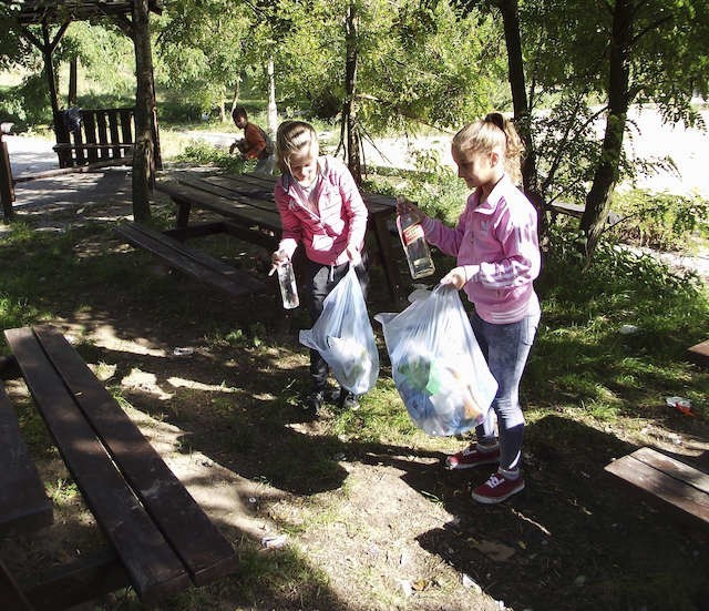 Nikola Pieńkowska i Oliwia Furmańska sprzątają teren przy ul. Olsztyńskiej