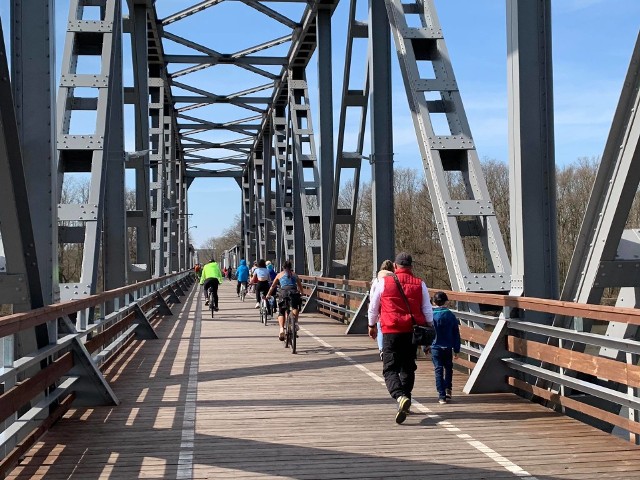 Dawny most kolejowy w Stanach (powiat nowosolski) to jedna z najciekawszych atrakcji turystycznych w Lubuskiem. Świadczy o tym choćby popularność, jaką cieszy się ta konstrukcja. W niedzielę, 11 kwietnia, most odwiedziły istne tłumy. Byli spacerowicze, rolkarze, rowerzyści. To świetne miejsce na rodzinną wycieczkę! Most w Stanach ma niemal 650 merów długości, z czego 100 metrów prowadzi nad nurtem rzeki. Konstrukcja powstała w 1908 r. W 1945 wycofujący się Niemcy podłożyli na moście ładunki wybuchowe. Przeprawa ucierpiała, ale doczekała się odbudowy w 1955 r. Później działała tu linia kolejowa Żagań-Wolsztyn. W latach 90. trasa przestała być używana przez kolej. Z czasem rozebrano tory kolejowe. Staraniem Nowej Soli powstała tu ścieżka rowerowa. Inwestycja okazała się strzałem w dziesiątkę!W pogodne dni na moście w Stanach są tłumy spacerowiczów, rowerzystów i miłośników aktywnego wypoczynku. Często miejsce to odwiedzają cale rodziny. Wideo: Cigacice, Odra i most z lotu ptaka