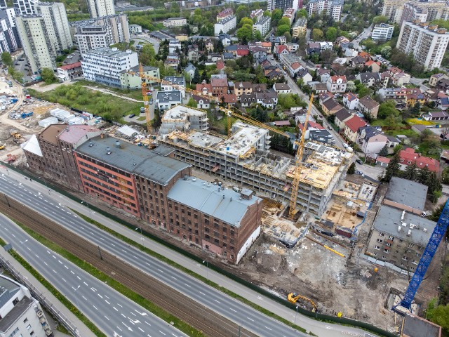 Kraków, ulica Mogilska. Między nasypem kolejowym a ul. Meissnera powstał las nowych bloków, a kolejne są w budowie. Przykleiły się do niskiej zabudowy w głębi tego terenu. Nowych dróg na razie jak na lekarstwo.